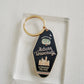 Navy blue enamel keychain on a gold chain with Auburn University written on it.