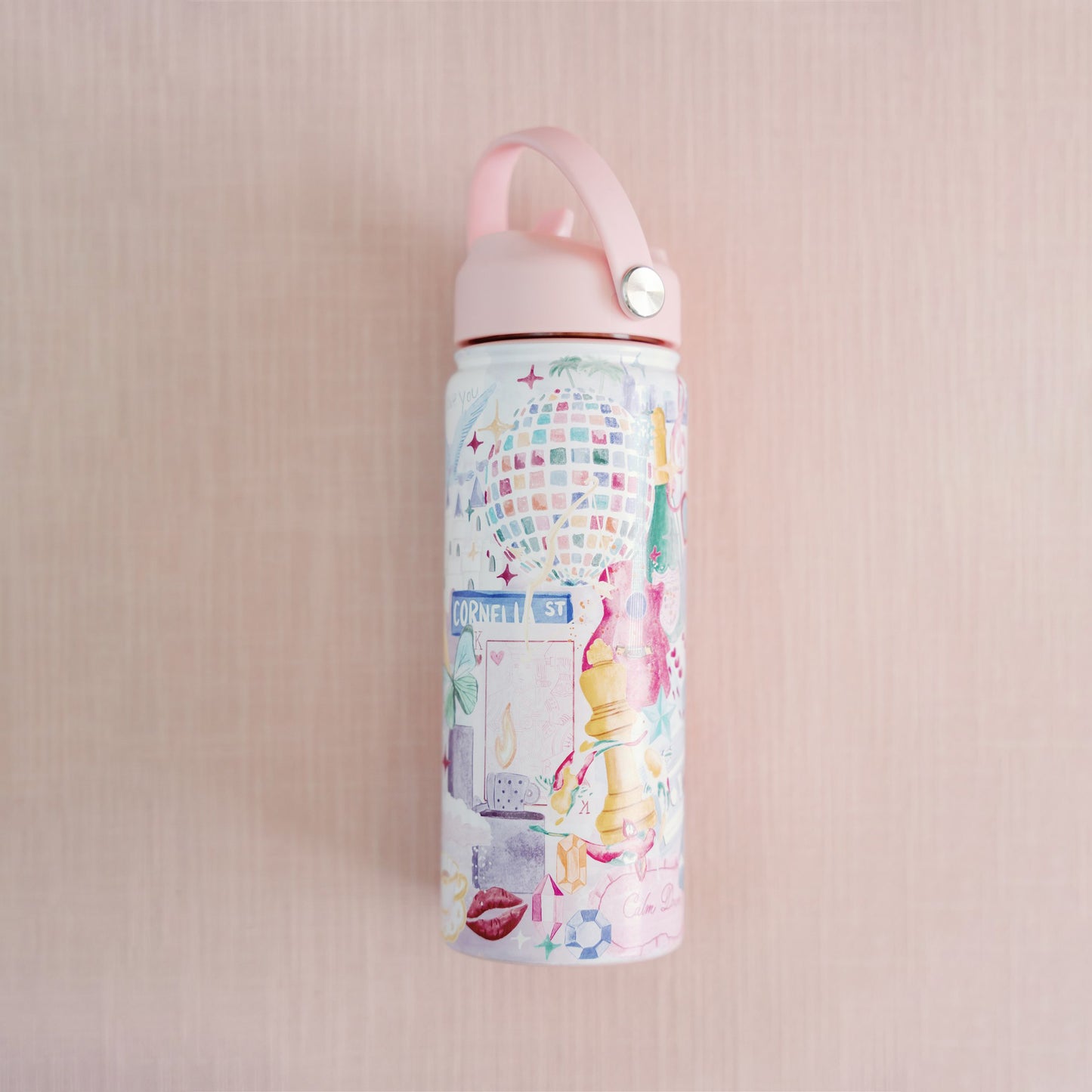 18 ounce insulated water bottle with light pink lid and watercolor Taylor Swift symbols.