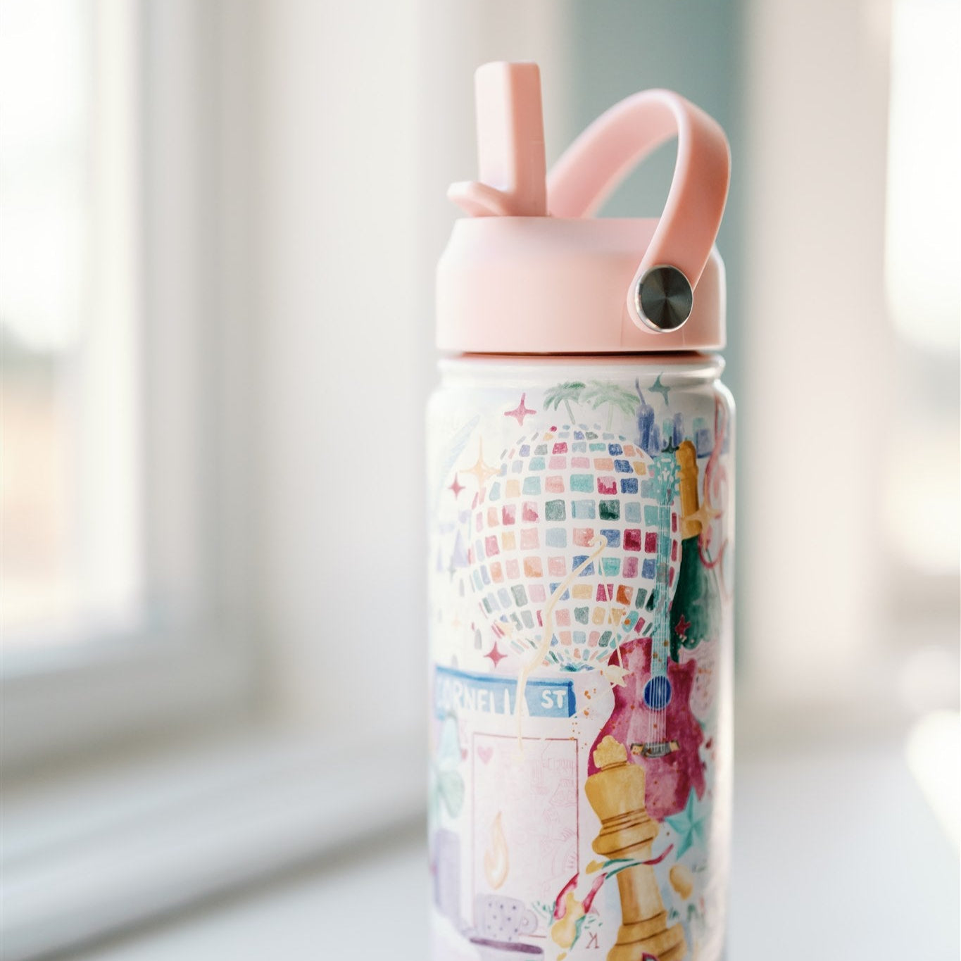 18 ounce insulated water bottle with light pink lid and watercolor Taylor Swift symbols.