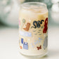 Clear glass with Taylor Swift symbols on it.