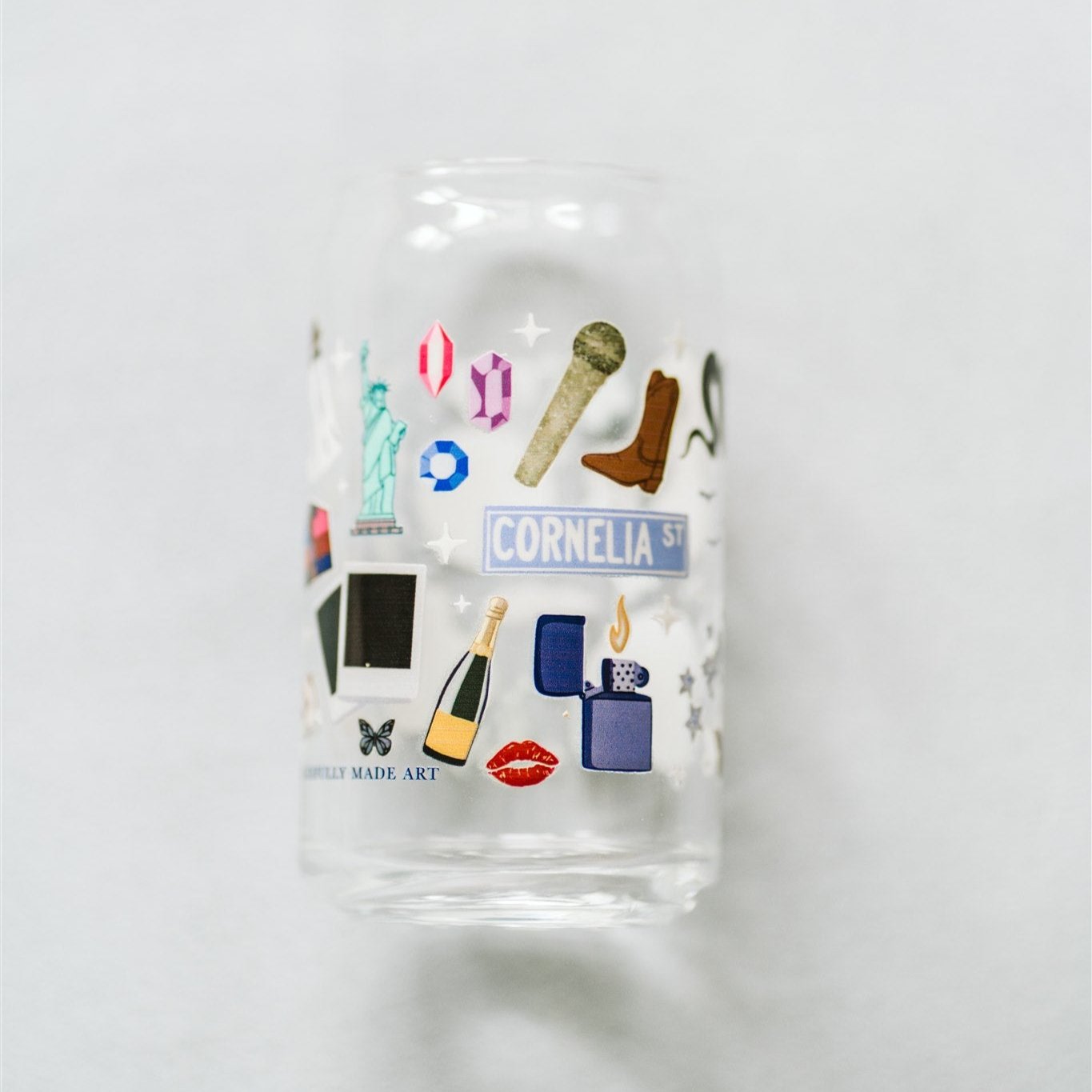 Clear glass with Taylor Swift symbols on it.