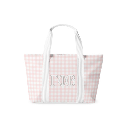 Tote bag with pink and white checkered pattern and 'Gamma Phi Beta' monogram on a white background