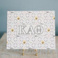 Art print with Kappa Alpha Theta design on a stand against a blue background
