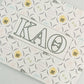 Art print with Kappa Alpha Theta Greek letters and a yellow and black pattern on a white background.