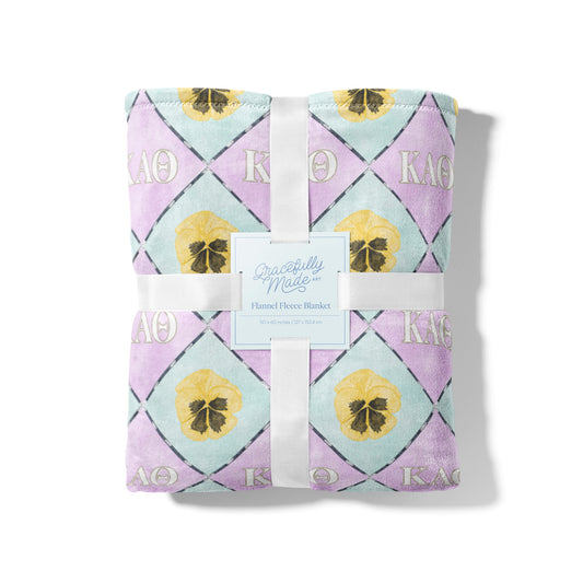 Purple and light blue checkered fleece blanket with Kappa Alpha Theta Greek letters.