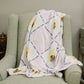 Purple and blue checkered fleece blanket with Kappa Alpha Theta greek letters draped over a chair.