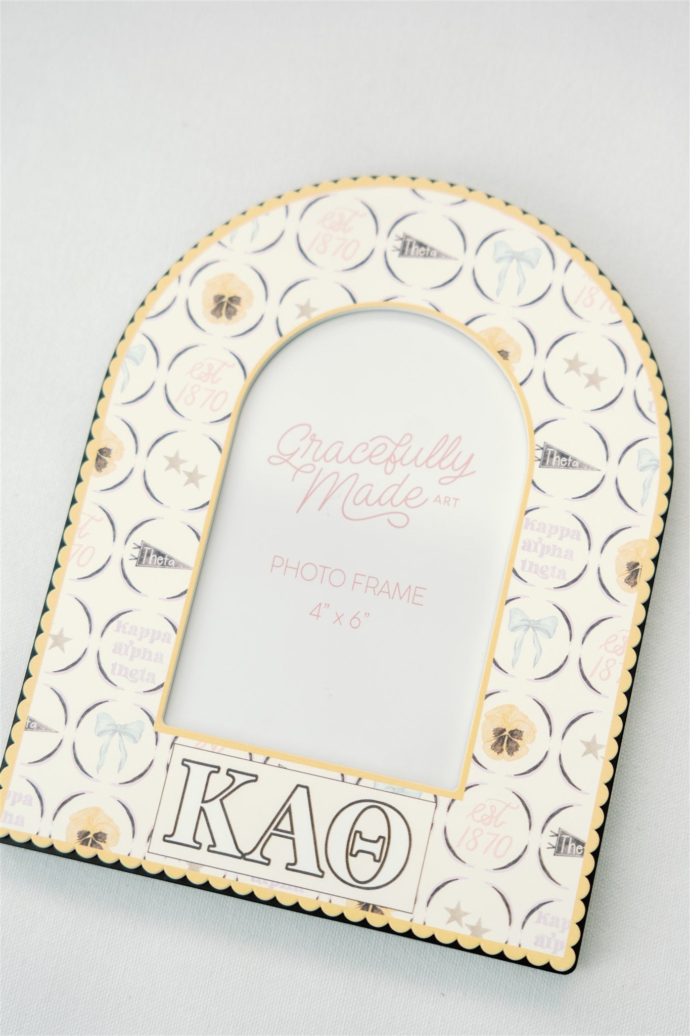 Arched photo frame with Kappa Alpha Theta pattern and Greek letters on a white background.