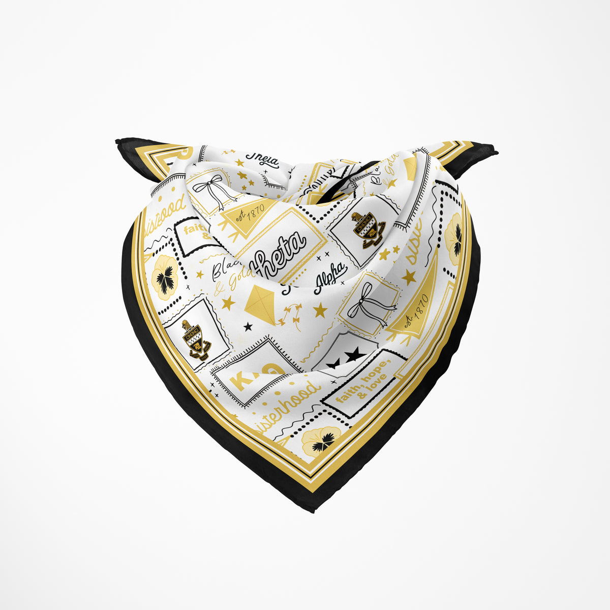 A folded and tied silk scarf featuring Kappa Alpha Theta Greek letters and sorority themed illustrations including a kite, flower, and bow on a light grey background with a black and gold border.