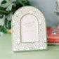 Decorative photo frame with Kappa Delta pattern and Greek letters on a green surface.