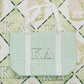Green checkered tote bag with Kappa Delta letters on a patterned background.