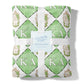 Green and white patterned fleece blanket with 'Kappa Delta' symbols, tied with a ribbon, on a white background.
