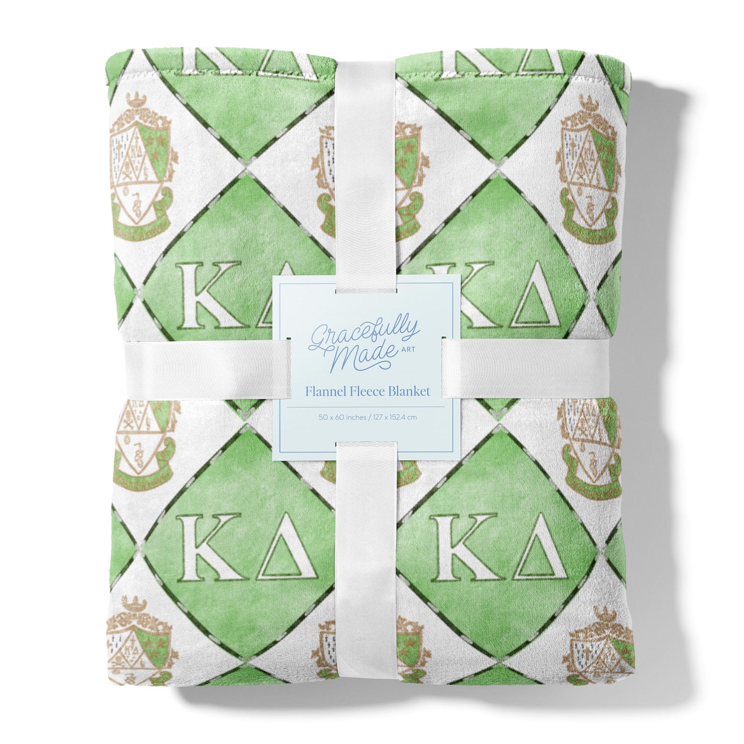 Green and white patterned fleece blanket with 'Kappa Delta' symbols, tied with a ribbon, on a white background.