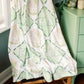 Blanket with Kappa Delta Greek letter symbols draped over a chair in a room with green walls.