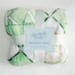 Green and white flannel fleece blanket with a Gracefully Made Art branding card