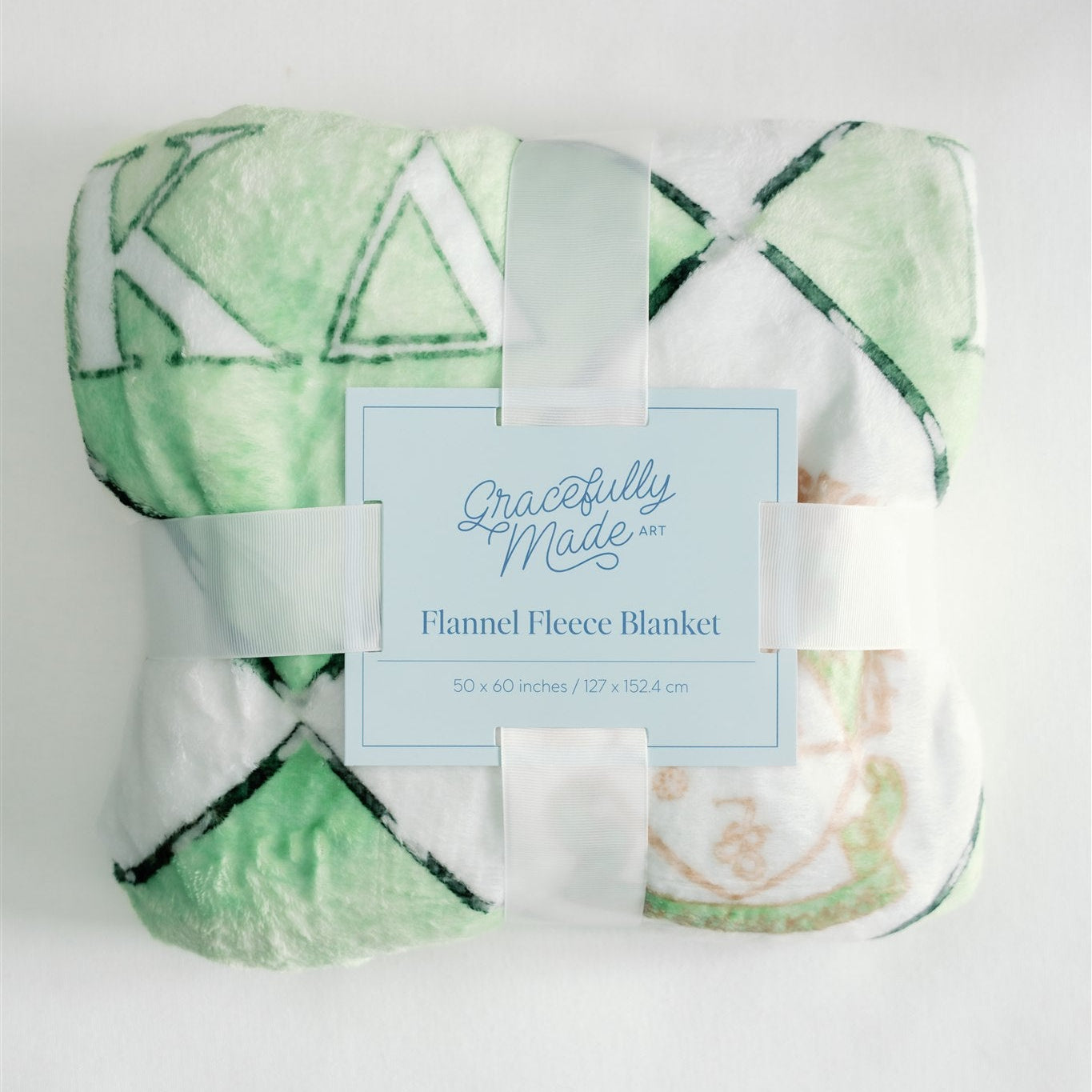 Green and white flannel fleece blanket with a Gracefully Made Art branding card