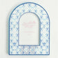Decorative arched picture frame with blue and white pattern and 'Kappa Kappa Gamma' letters on a light gray background