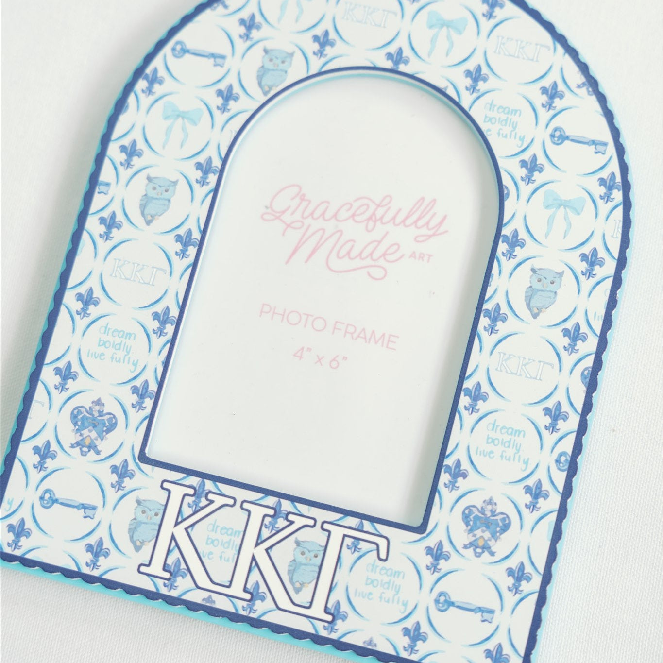 Decorative frame with blue and white pattern and 'Kappa Kappa Gamma' letters on a white background