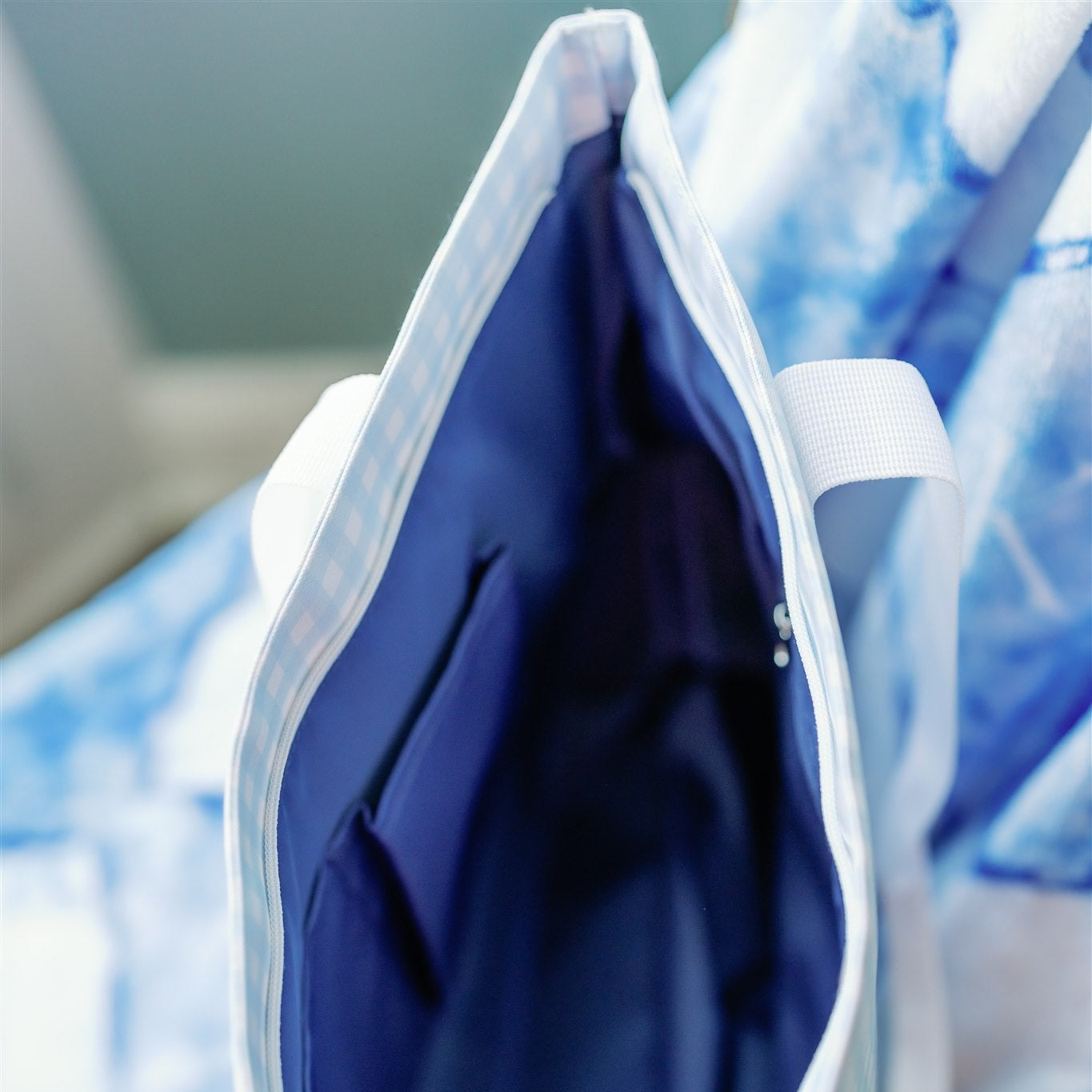 Close-up of the Kappa Kappa Gamma tote bag's dark blue interior liner and pockets