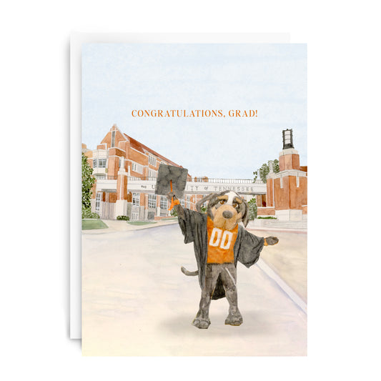 Card with Tennessee's mascot in a graduation gown and cap, standing in front of a college campus with 'Congratulations, Grad!' text.