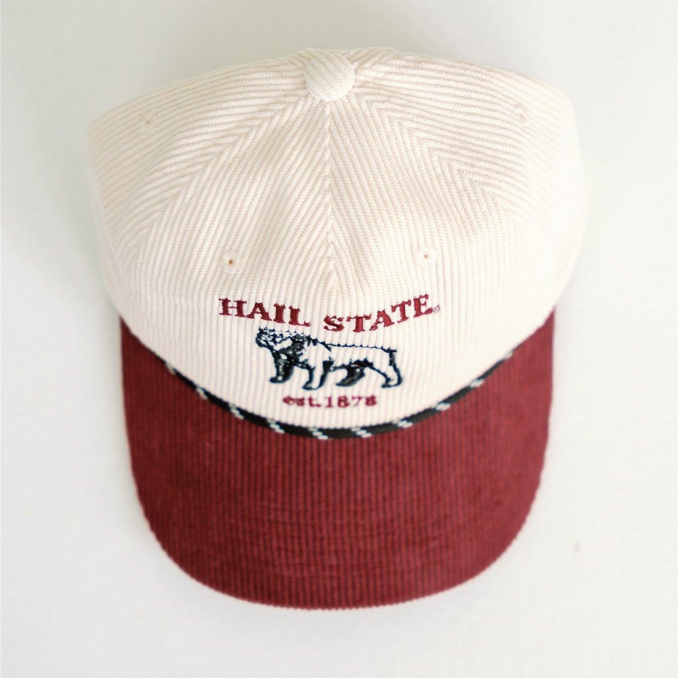 Baseball cap with 'Hail State' and the bulldog logo on a white background