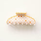 Orange checkered hair clip with scalloped edge on a white background