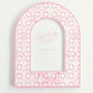 Pink arch-shaped picture frame with circular patterns and Phi Mu Greek letters on a white background