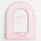 Pink arch-shaped photo frame with circular patterns and Phi Mu Greek letters on a white background