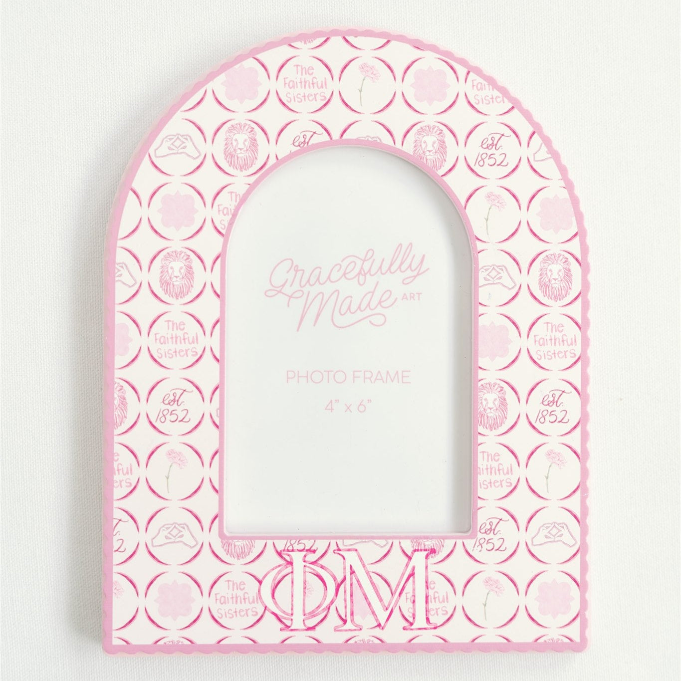 Pink arch-shaped photo frame with circular patterns and Phi Mu Greek letters on a white background