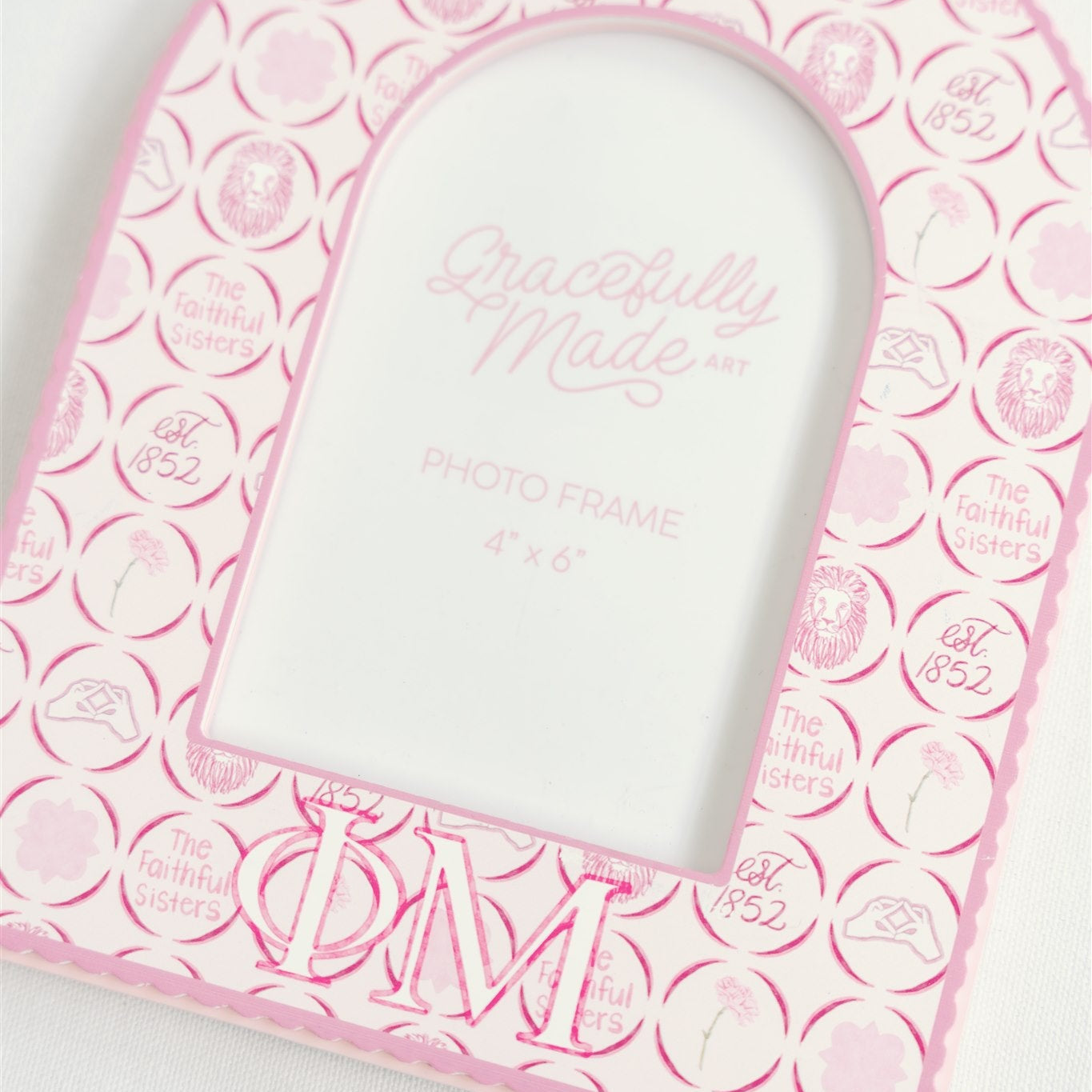 Pink photo frame with Phi Mu Greek letters and 'Gracefully Made Art' branding on a white background