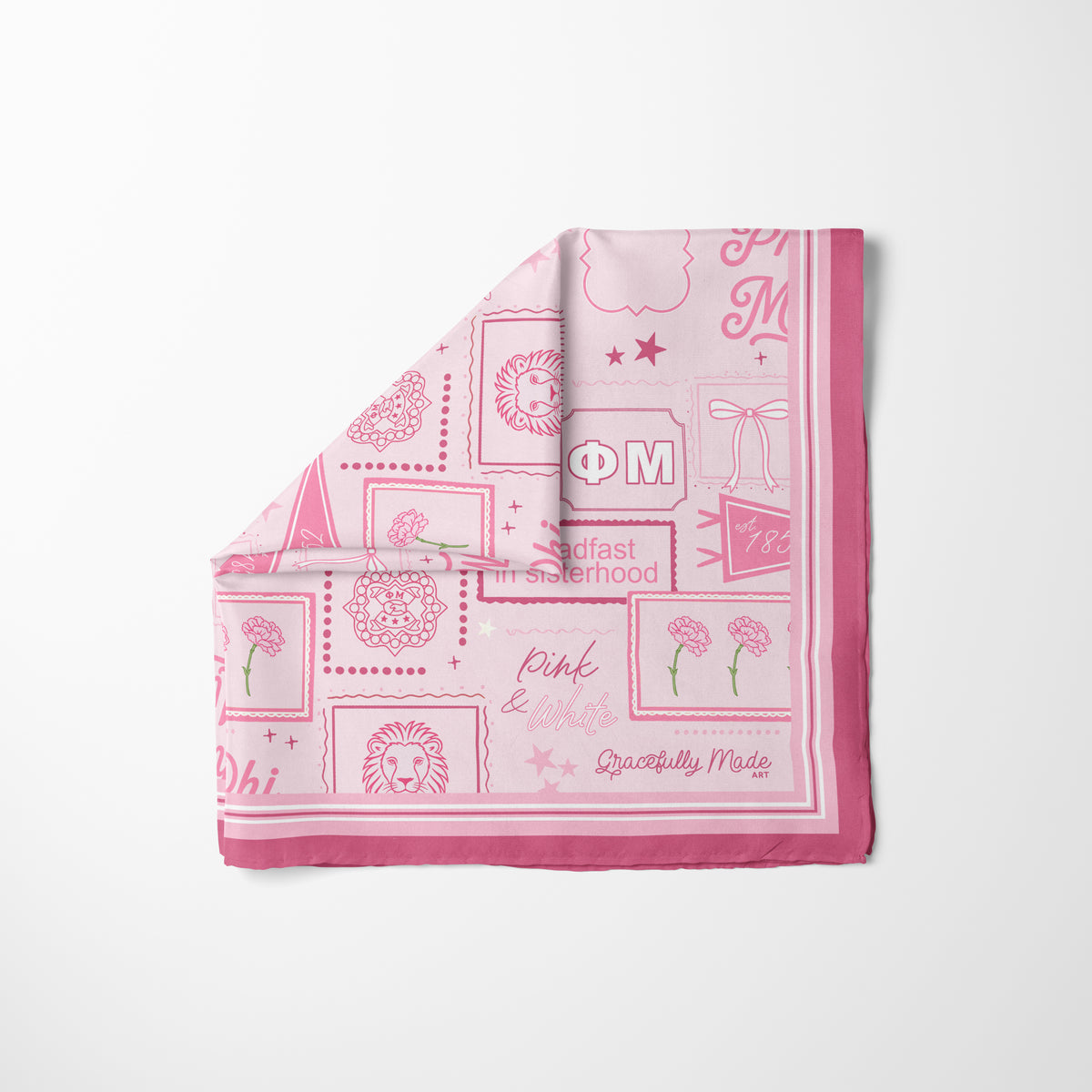 A folded light pink silk scarf with a light pink background, dark pink border and Phi Mu Greek letters and themed illustrations on it displayed on a white background.
