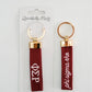 Front and back of the red keychain with Phi Sigma Rho embroidered on it in white.