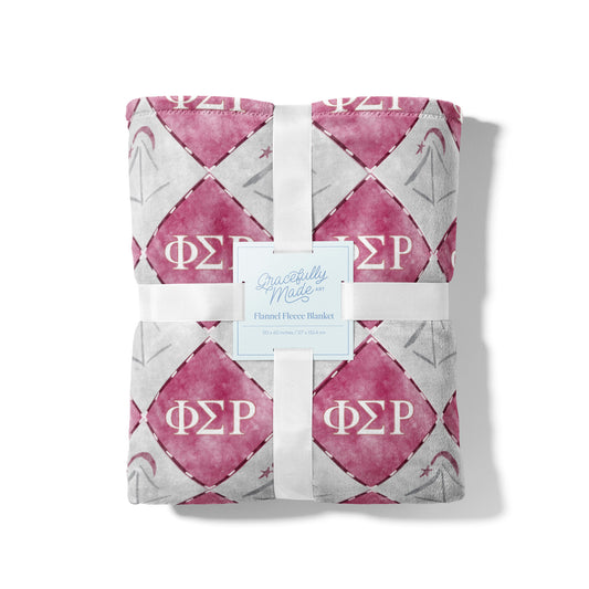 Folded pink and gray blanket with Phi Sigma Rho Greek letters on a white background