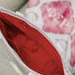 Close-up of the Phi Sigma Rho tote bag's red interior liner and pockets