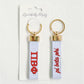 Front and back of the Pi Beta Phi embroidered keychain with Gracefully Made Art branded packaging. 
