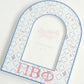 Decorative arch with Pi Beta Phi Greek letters on a light background