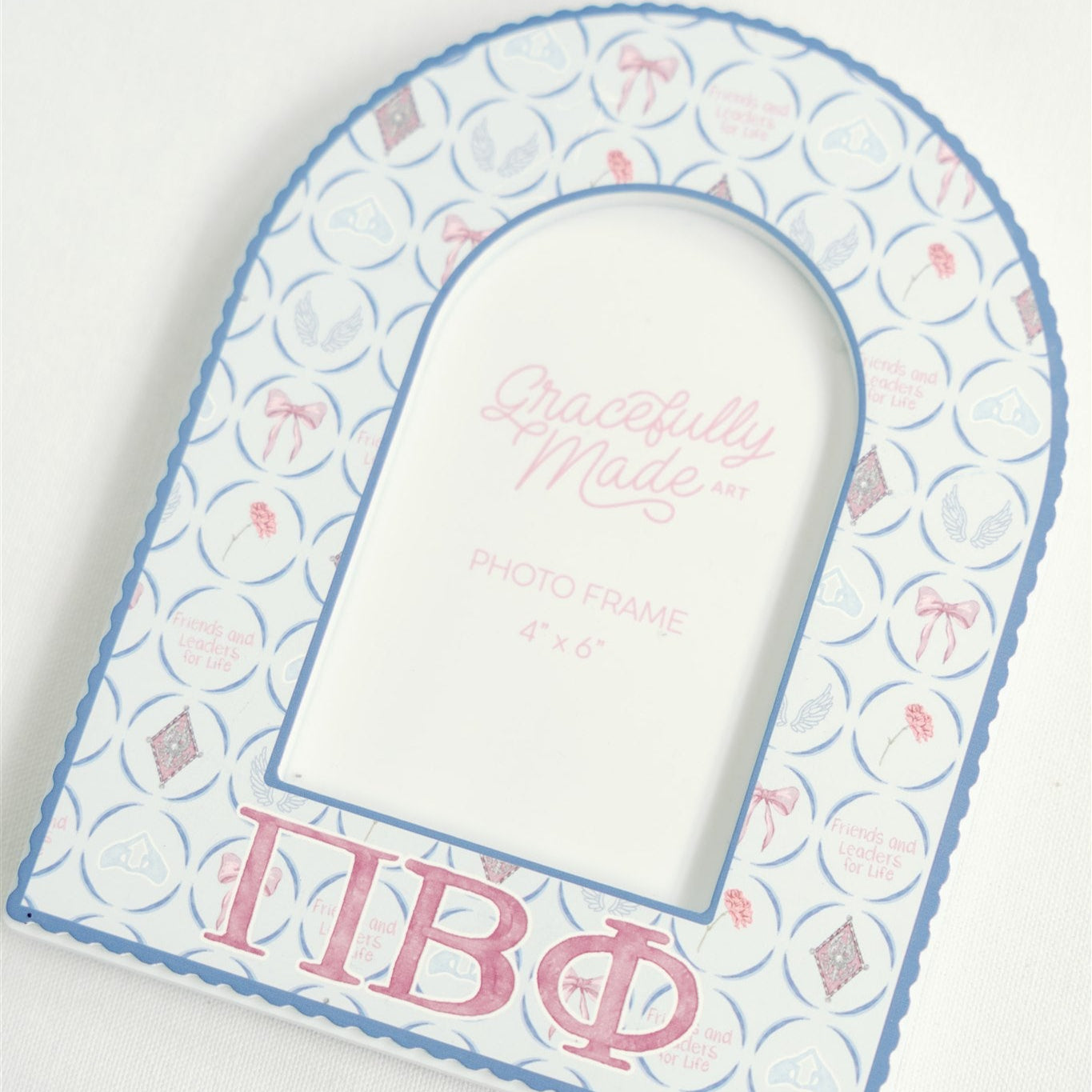 Decorative arch with Pi Beta Phi Greek letters on a light background