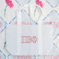 Gray checkered tote bag with Pi Beta Phi Greek letters and white straps on a patterned background.