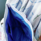 Close up of Pi Beta Phi tote bag deep blue interior liner and pockets.