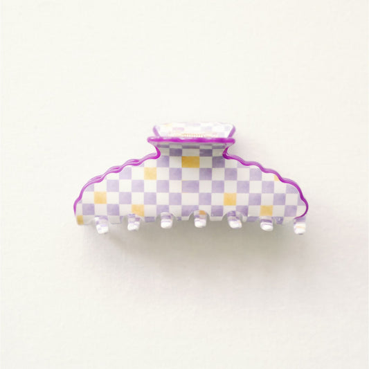 Checkered hair clip with purple border on a white background