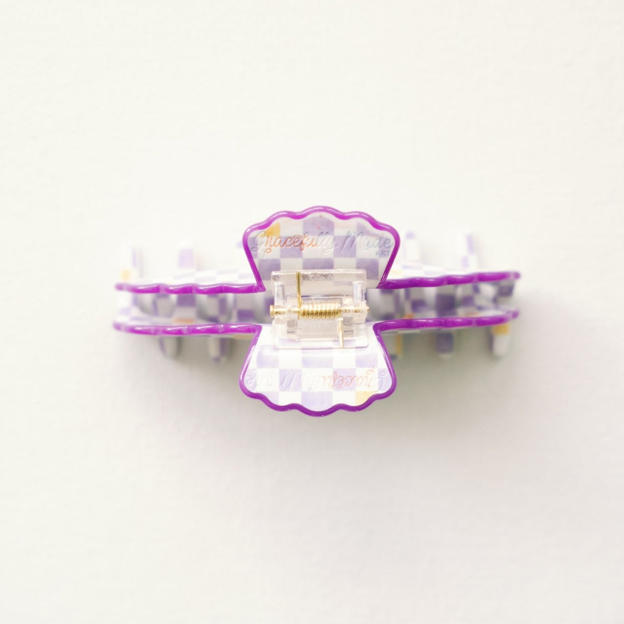 Hair clip with purple and white design on a white background