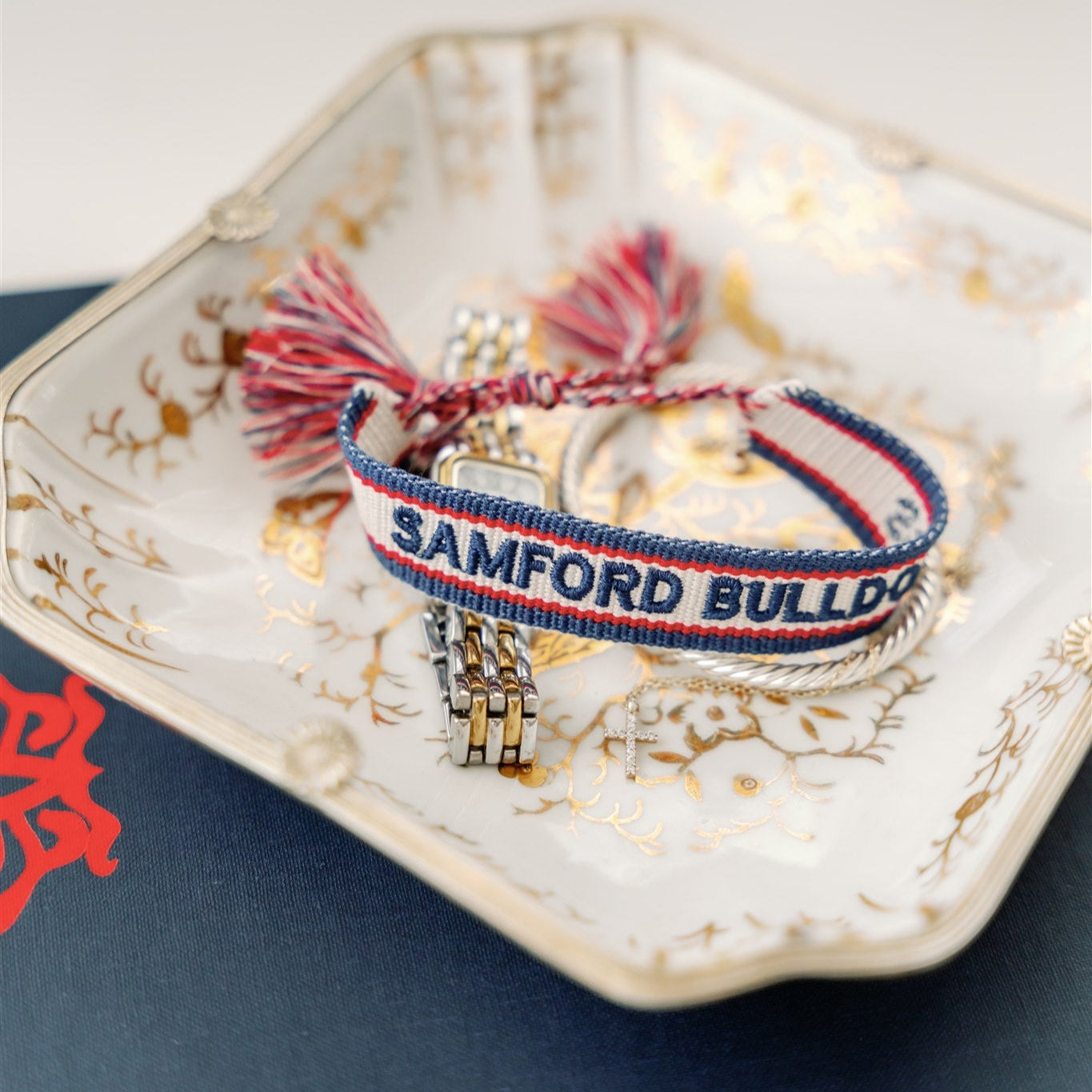 White, navy, and red woven bracelet with "Samford Bulldogs" written on it.