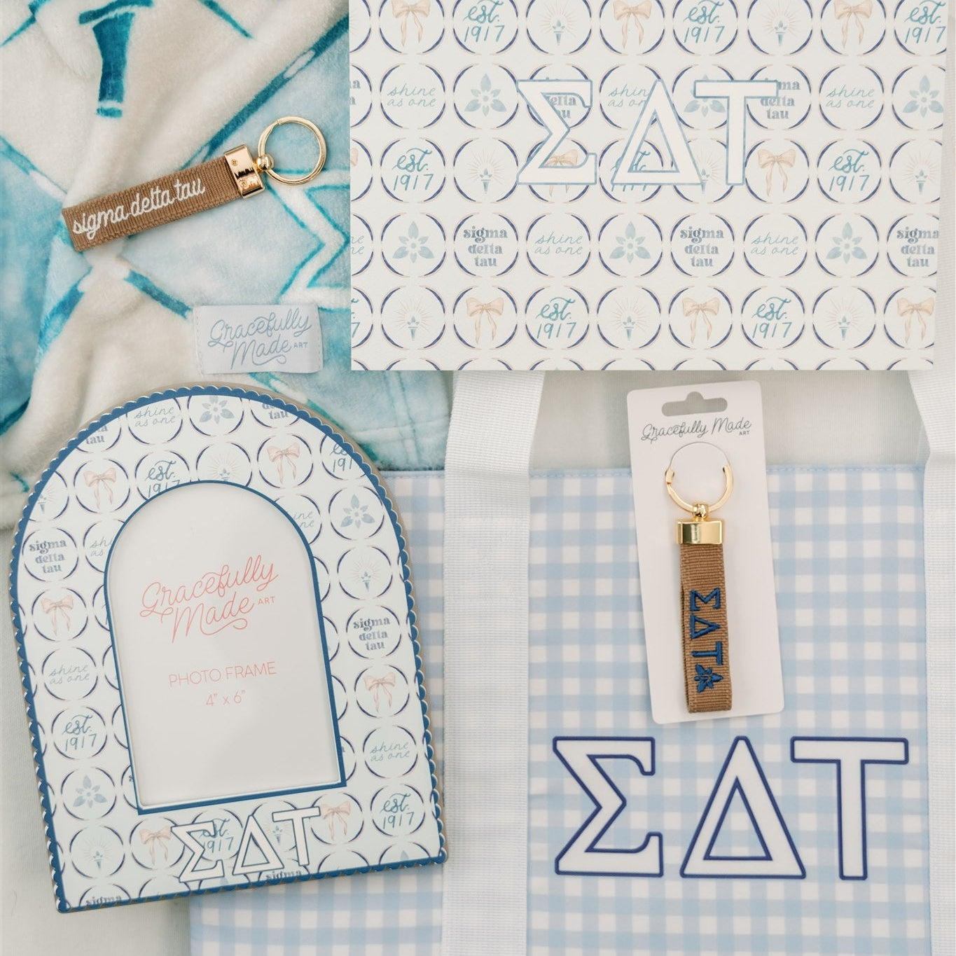 Collection of Sigma Delta Tau themed products including an art print, keychain, and photo frame