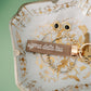 Sigma Delta Tau embroidered on a keychain set on a decorative jewelry dish.