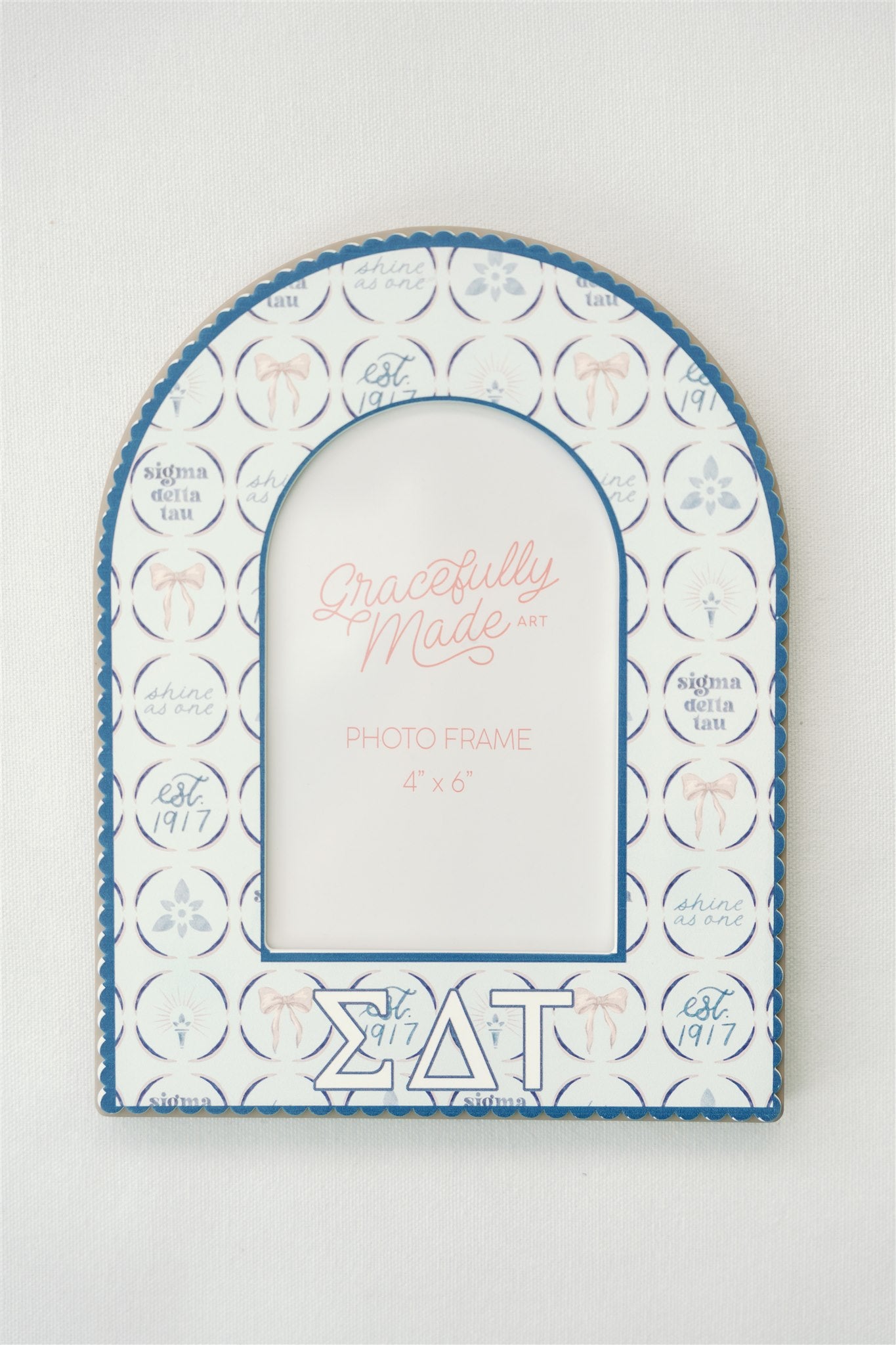 Decorative photo frame with Sigma Delta Tau Greek letters and pattern on a white background.