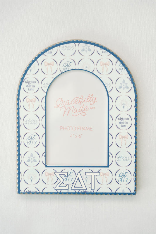 Decorative photo frame with Sigma Delta Tau Greek letters and pattern on a white background.