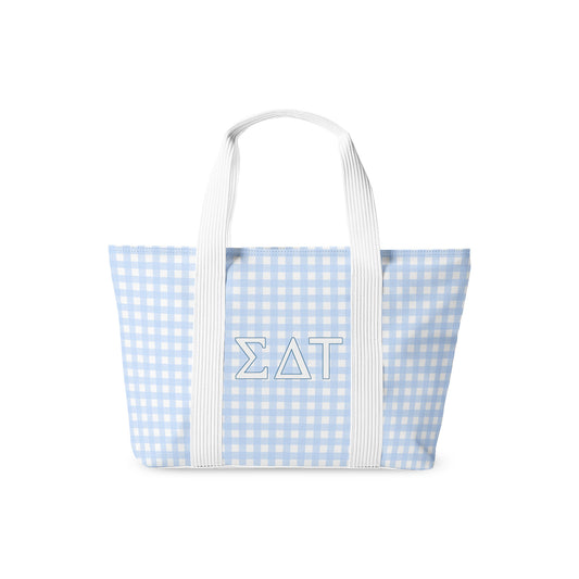Blue and white checkered tote bag with Sigma Delta Tau Greek letters and white handles on a white background