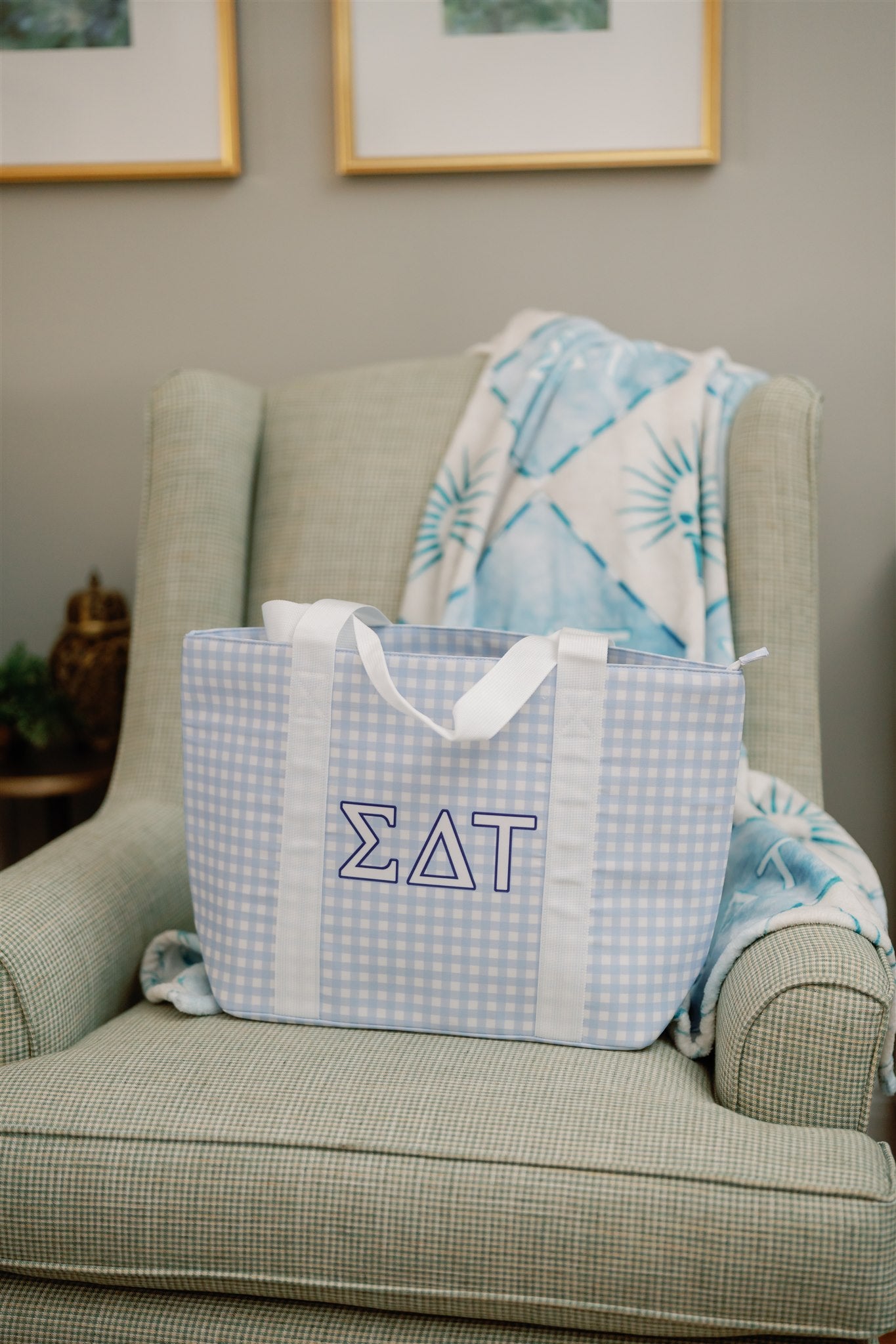 Sigma Delta Tau bag on a green armchair with a blue and white patterned blanket