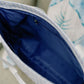 Close up of the Sigma Delta Tau tote bag's deep blue interior liner and zipper pocket.