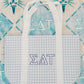 Blue checkered tote bag with white handles and Sigma Delta Tau Greek letters on a patterned background.