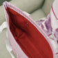 Close-up of the Sigma Kappa tote bag's red interior liner and zipper pocket